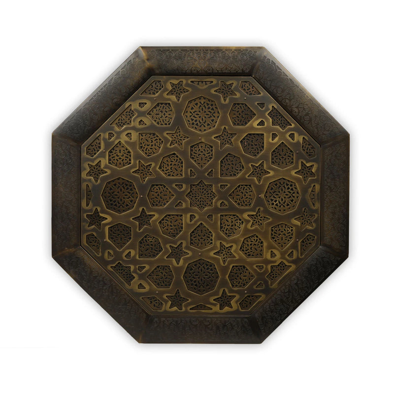 Top view of brass coffee table showcasing handcarved Moorish star motifs 