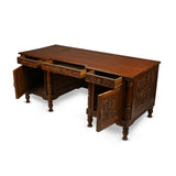 Anglede View of Antique Carved Wooden Desk with open Chest of Drawers and storage space